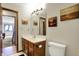 Bathroom featuring a wood vanity with a white sink and a toilet to the right at 8072 Foxchase Dr, Indianapolis, IN 46256