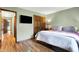 Bedroom with a bed, hardwood floors, and a closet with dark wood doors at 8072 Foxchase Dr, Indianapolis, IN 46256