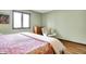 Light filled bedroom with a comfortable cream colored chair, matching dresser, and a red floral bedspread at 8072 Foxchase Dr, Indianapolis, IN 46256