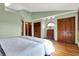 Spacious bedroom with hardwood floors and an ensuite bathroom at 8072 Foxchase Dr, Indianapolis, IN 46256