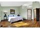 Bright bedroom with hardwood floors and easy access to the ensuite bathroom at 8072 Foxchase Dr, Indianapolis, IN 46256