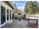 A home's wood deck features an umbrella, table and chairs, and serene outdoor space at 8072 Foxchase Dr, Indianapolis, IN 46256
