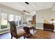 Well-lit dining area featuring wood floors and views of the outdoors at 8072 Foxchase Dr, Indianapolis, IN 46256
