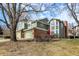Exterior of townhomes with green siding and brick accents with attached garages and lawns with trees at 8072 Foxchase Dr, Indianapolis, IN 46256
