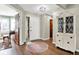 Welcoming foyer features hardwood floors, decorative rug, and a stylish cabinet for an inviting entrance at 8072 Foxchase Dr, Indianapolis, IN 46256