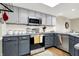 Kitchen featuring granite countertops, stainless steel appliances, and gray cabinets at 8072 Foxchase Dr, Indianapolis, IN 46256