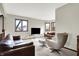 Bright living room with neutral carpet, modern seating, and large windows offering natural light at 8072 Foxchase Dr, Indianapolis, IN 46256