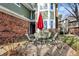 A stone patio shows a four-chair table set near the entrance of the home at 8072 Foxchase Dr, Indianapolis, IN 46256