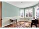 Bright sitting room with three windows, neutral walls, and wooden floors, offering a comfortable living space at 8072 Foxchase Dr, Indianapolis, IN 46256