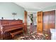 Sitting room with hardwood floors, piano and natural light providing a charming view of the interiors at 8072 Foxchase Dr, Indianapolis, IN 46256