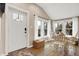Sunlit dining area with white table and chairs, near the entryway at 8598 S Riser Dr, Nineveh, IN 46164