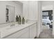 Bright bathroom with double sinks, white countertops and a view of a beautifully decorated main bedroom at 8885 Lowell St, McCordsville, IN 46055