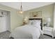 Cozy bedroom with modern lighting, stylish wall decor, and plush white bedding at 8885 Lowell St, McCordsville, IN 46055