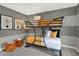 A playful bunk bed contrasts against gray and white striped walls in a well-lit bedroom at 8885 Lowell St, McCordsville, IN 46055