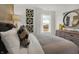 Bright bedroom featuring accent wall art, modern decor, and window view at 8885 Lowell St, McCordsville, IN 46055