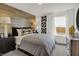 Comfortable bedroom featuring wood accent wall, cozy bed, and bright window views at 8885 Lowell St, McCordsville, IN 46055