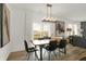 Bright dining room with a modern light fixture, table and chairs, and large windows to let in natural light at 8885 Lowell St, McCordsville, IN 46055