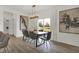Bright dining room with a modern light fixture, table and chairs, and large windows to let in natural light at 8885 Lowell St, McCordsville, IN 46055
