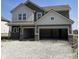 Two-story home featuring a two-car garage, varied siding, and brick facade accents at 8885 Lowell St, McCordsville, IN 46055