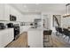 Modern kitchen features stainless steel appliances, white cabinetry, and a spacious center island for food preparation at 8885 Lowell St, McCordsville, IN 46055