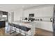 Modern kitchen with bright cabinets, an island with barstool seating, and stainless-steel appliances at 8885 Lowell St, McCordsville, IN 46055
