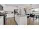 Modern kitchen features stainless steel appliances, white cabinetry, and a spacious center island for food preparation at 8885 Lowell St, McCordsville, IN 46055