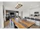 Open concept living space features dining table with seating, living room with sofa and kitchen area at 8885 Lowell St, McCordsville, IN 46055