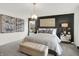 A luxurious main bedroom features a statement wall, elegant furnishings, and contemporary lighting at 8885 Lowell St, McCordsville, IN 46055