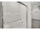 A bright and clean walk-in shower with glass doors and convenient built-in seating at 8885 Lowell St, McCordsville, IN 46055