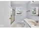 Well-lit bathroom with vanity, tiled floor, and shower/tub combination by the window at 9031 Butternut Ct, Indianapolis, IN 46260