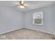 Comfortable bedroom with neutral paint, plush carpeting, and natural light streaming through the window at 9031 Butternut Ct, Indianapolis, IN 46260