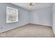 Bright bedroom with plush carpeting, a large window letting in natural light, and soothing pastel blue walls at 9031 Butternut Ct, Indianapolis, IN 46260