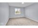 Cozy bedroom with natural light, plush carpeting, and neutral paint at 9031 Butternut Ct, Indianapolis, IN 46260