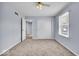 Cozy bedroom with soft blue walls, neutral carpet, and a ceiling fan for added comfort at 9031 Butternut Ct, Indianapolis, IN 46260