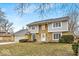 Charming two-story home with a stone and siding facade, attached garage, and a well-maintained front lawn at 9031 Butternut Ct, Indianapolis, IN 46260