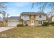 Charming two-story home with a stone and siding facade, attached garage, and a well-maintained front lawn at 9031 Butternut Ct, Indianapolis, IN 46260