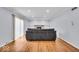 Living room with hardwood floors, white trim, and a sliding glass door to the backyard at 9031 Butternut Ct, Indianapolis, IN 46260