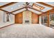 Spacious living room featuring vaulted ceilings, exposed wood beams, skylights, and a stone fireplace at 9031 Butternut Ct, Indianapolis, IN 46260