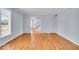 Inviting living room with hardwood floors, view of the staircase, and white trim at 9031 Butternut Ct, Indianapolis, IN 46260