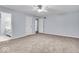 Spacious main bedroom featuring neutral paint, plush carpeting, and a ceiling fan at 9031 Butternut Ct, Indianapolis, IN 46260