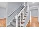 Carpeted staircase with white risers and wood treads lead to the upper level of this home at 9031 Butternut Ct, Indianapolis, IN 46260
