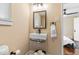 Updated bathroom features modern fixtures, sleek tiling, and a sink and toilet at 916 N Bradley Ave, Indianapolis, IN 46201