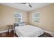 Bright bedroom with a window, a ceiling fan and hardwood floors at 916 N Bradley Ave, Indianapolis, IN 46201