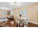 Inviting dining space with hardwood floors, modern chandelier, and a view of the living room at 916 N Bradley Ave, Indianapolis, IN 46201