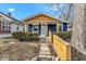 Charming blue bungalow with wood accents and landscaped walkway at 916 N Bradley Ave, Indianapolis, IN 46201
