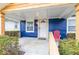 Charming blue home featuring a cozy front porch, white door, and classic architectural details at 916 N Bradley Ave, Indianapolis, IN 46201