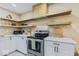 Well-equipped kitchen featuring sleek appliances, ample counter space, and floating open shelves at 916 N Bradley Ave, Indianapolis, IN 46201