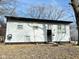 Ranch home with gray siding, black accents, and a landscaped yard at 9508 Conried Dr, Indianapolis, IN 46235
