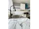 Modern kitchen with marble countertops and a black gooseneck faucet at 9508 Conried Dr, Indianapolis, IN 46235
