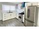 Modern kitchen with white cabinets, stainless steel appliances, and marble countertops at 9508 Conried Dr, Indianapolis, IN 46235